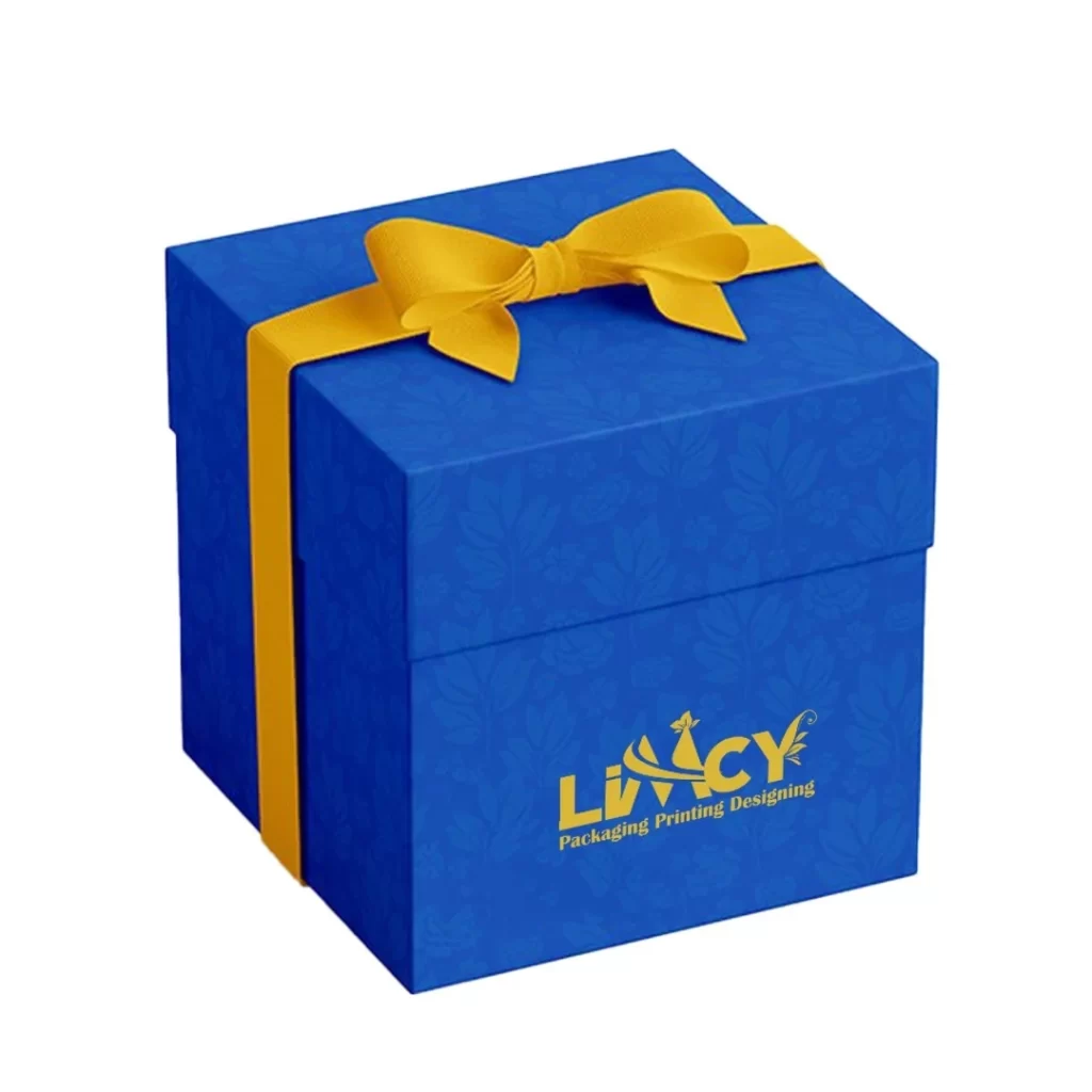A blue rigid gift box adorned with a ribbon and featuring a logo on the front.