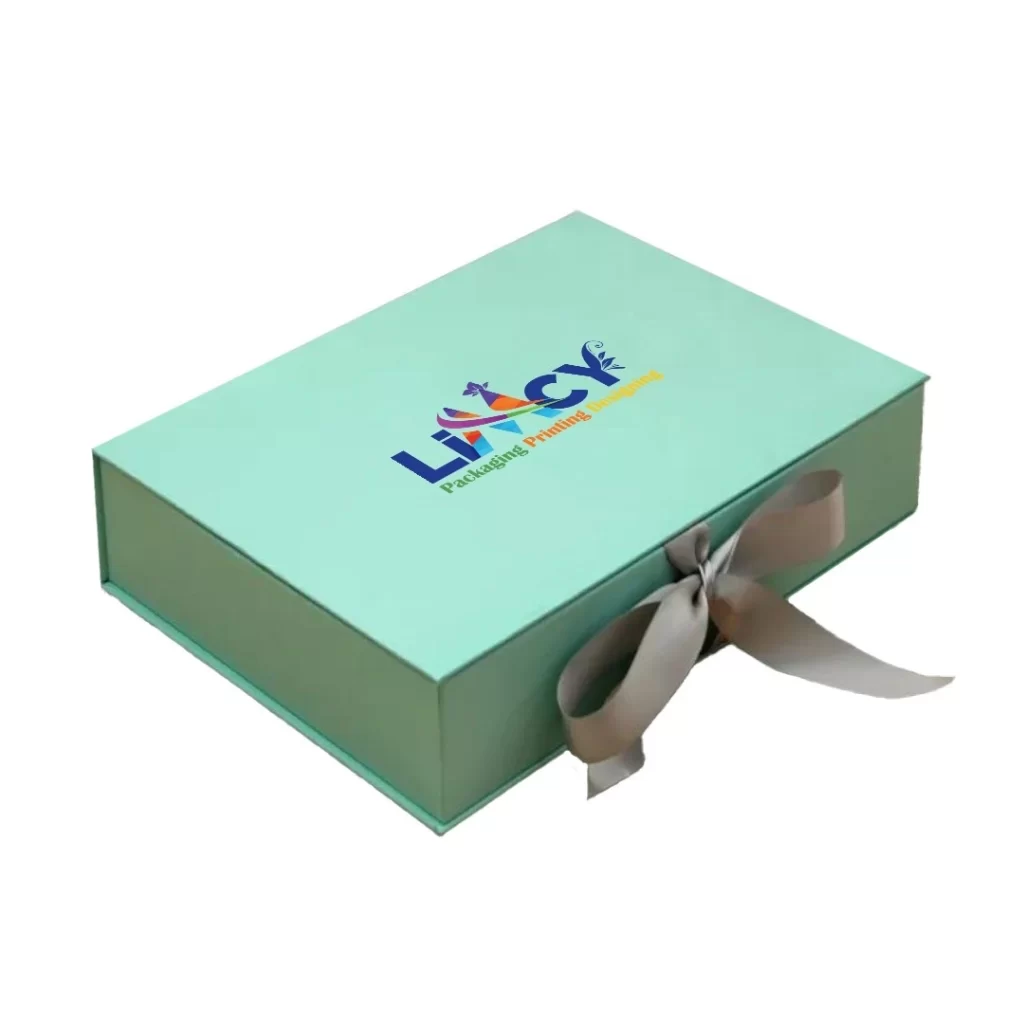 A green rigid gift box adorned with a ribbon and featuring a logo on the front.