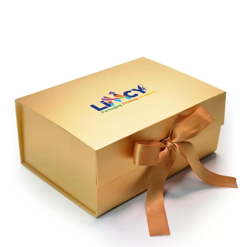A golden-colored gift box adorned with a ribbon and featuring a logo on the front.